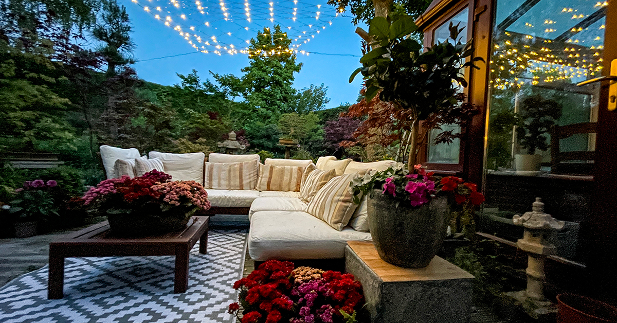 Outdoor lounging area at night_1200x628