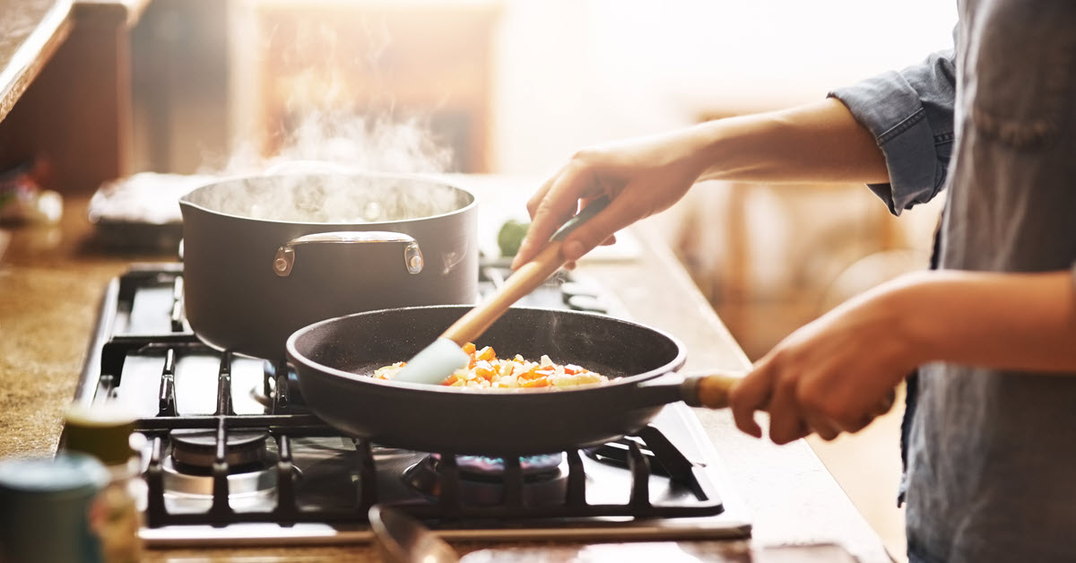 Woman cooking on stove