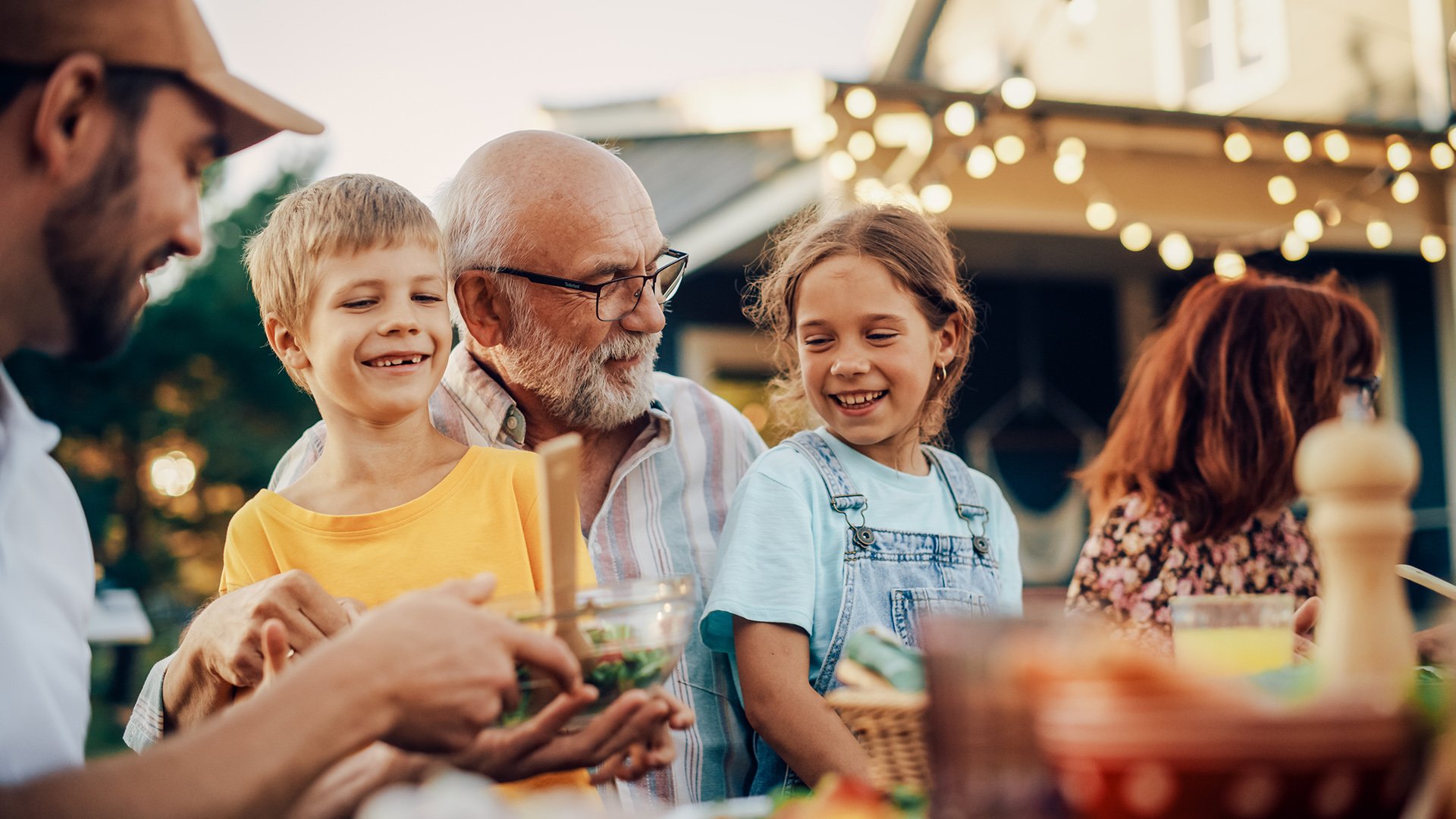 A happy family enjoying a backyard barbeque.